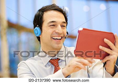 Stock Image - Business man with digital tablet. Fotosearch