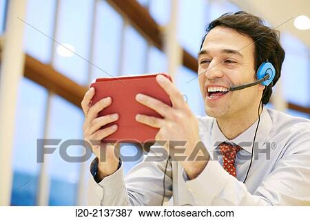 Stock Photo - Business man with digital tablet. Fotosearch