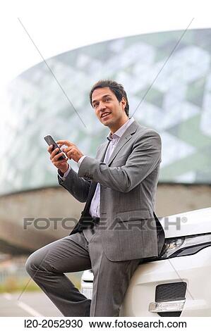 Business man with smartphone in parking business center. San Sebastian Technology Park. Donostia. Gipuzkoa. Basque Country. Spain. View Large Photo Image Stock Image - Business man with smartphone in parking business center. San Sebastian Technology Park. Donostia. Gipuzkoa. Basque Country. Spain.. Fotosearch