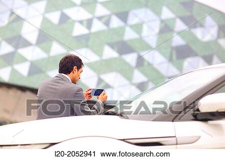 Business man with smartphone in parking business center. San Sebastian Technology Park. Donostia. Gipuzkoa. Basque Country. Spain. View Large Photo Image Stock Image - Business man with smartphone in parking business center. San Sebastian Technology Park. Donostia. Gipuzkoa. Basque Country. Spain.. Fotosearch