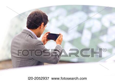Business man with smartphone in parking business center. San Sebastian Technology Park. Donostia. Gipuzkoa. Basque Country. Spain. View Large Photo Image Stock Photo - Business man with smartphone in parking business center. San Sebastian Technology Park. Donostia. Gipuzkoa. Basque Country. Spain.. Fotosearch