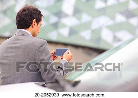 Business man with smartphone in parking business center. San Sebastian Technology Park. Donostia. Gipuzkoa. Basque Country. Spain. View Large Photo Image Stock Photo - Business man with smartphone in parking business center. San Sebastian Technology Park. Donostia. Gipuzkoa. Basque Country. Spain.. Fotosearch