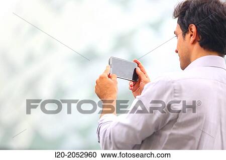 Business man with smartphone in business center. San Sebastian Technology Park. Donostia. Gipuzkoa. Basque Country. Spain. View Large Photo Image Stock Image - Business man with smartphone in business center. San Sebastian Technology Park. Donostia. Gipuzkoa. Basque Country. Spain.. Fotosearch