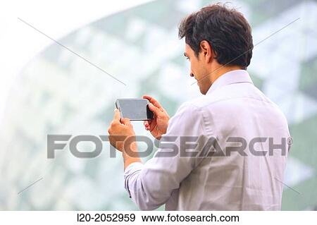 Business man with smartphone in business center. San Sebastian Technology Park. Donostia. Gipuzkoa. Basque Country. Spain. View Large Photo Image Stock Photo - Business man with smartphone in business center. San Sebastian Technology Park. Donostia. Gipuzkoa. Basque Country. Spain.. Fotosearch