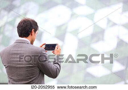 Stock Photography - Business man with smartphone in business center. San Sebastian Technology Park. Donostia. Gipuzkoa. Basque Country. Spain.. Fotosearch