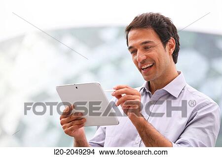 Business man with tablet in business center. San Sebastian Technology Park. Donostia. Gipuzkoa. Basque Country. Spain. View Large Photo Image Picture - Business man with tablet in business center. San Sebastian Technology Park. Donostia. Gipuzkoa. Basque Country. Spain.. Fotosearch