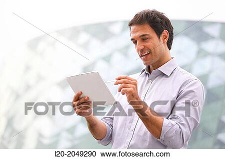 Business man with tablet in business center. San Sebastian Technology Park. Donostia. Gipuzkoa. Basque Country. Spain. View Large Photo Image Stock Image - Business man with tablet in business center. San Sebastian Technology Park. Donostia. Gipuzkoa. Basque Country. Spain.. Fotosearch