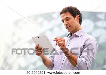 Business man with tablet in business center. San Sebastian Technology Park. Donostia. Gipuzkoa. Basque Country. Spain. View Large Photo Image Stock Image - Business man with tablet in business center. San Sebastian Technology Park. Donostia. Gipuzkoa. Basque Country. Spain.. Fotosearch