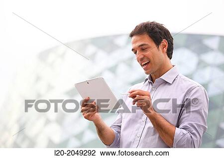 Business man with tablet in business center. San Sebastian Technology Park. Donostia. Gipuzkoa. Basque Country. Spain. View Large Photo Image Stock Image - Business man with tablet in business center. San Sebastian Technology Park. Donostia. Gipuzkoa. Basque Country. Spain.. Fotosearch