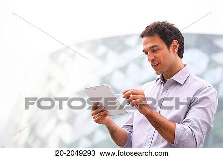 Business man with tablet in business center. San Sebastian Technology Park. Donostia. Gipuzkoa. Basque Country. Spain. View Large Photo Image Stock Image - Business man with tablet in business center. San Sebastian Technology Park. Donostia. Gipuzkoa. Basque Country. Spain.. Fotosearch