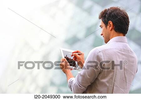 Business man with tablet in business center. San Sebastian Technology Park. Donostia. Gipuzkoa. Basque Country. Spain. View Large Photo Image Stock Image - Business man with tablet in business center. San Sebastian Technology Park. Donostia. Gipuzkoa. Basque Country. Spain.. Fotosearch