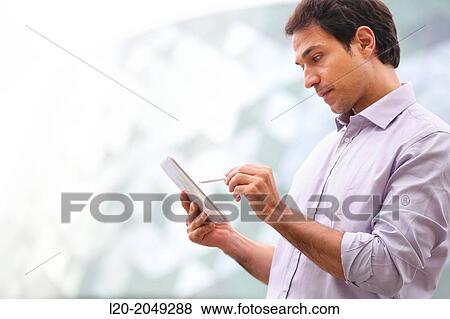 Business man with tablet in business center. San Sebastian Technology Park. Donostia. Gipuzkoa. Basque Country. Spain. View Large Photo Image Stock Photo - Business man with tablet in business center. San Sebastian Technology Park. Donostia. Gipuzkoa. Basque Country. Spain.. Fotosearch