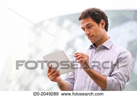 Business man with tablet in business center. San Sebastian Technology Park. Donostia. Gipuzkoa. Basque Country. Spain. View Large Photo Image Stock Photo - Business man with tablet in business center. San Sebastian Technology Park. Donostia. Gipuzkoa. Basque Country. Spain.. Fotosearch