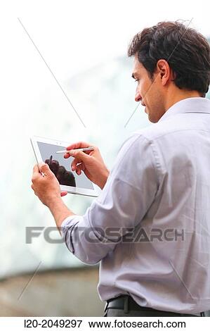 Business man with tablet in business center. San Sebastian Technology Park. Donostia. Gipuzkoa. Basque Country. Spain. View Large Photo Image Stock Photo - Business man with tablet in business center. San Sebastian Technology Park. Donostia. Gipuzkoa. Basque Country. Spain.. Fotosearch