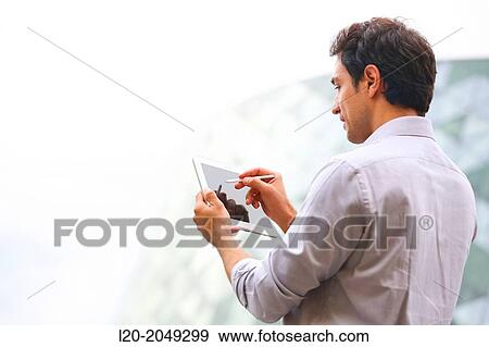 Business man with tablet in business center. San Sebastian Technology Park. Donostia. Gipuzkoa. Basque Country. Spain. View Large Photo Image Stock Photo - Business man with tablet in business center. San Sebastian Technology Park. Donostia. Gipuzkoa. Basque Country. Spain.. Fotosearch