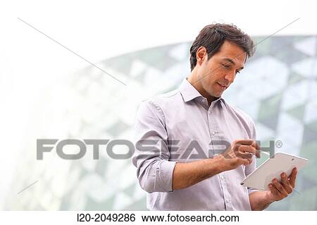 Business man with tablet in business center. San Sebastian Technology Park. Donostia. Gipuzkoa. Basque Country. Spain. View Large Photo Image Stock Photograph - Business man with tablet in business center. San Sebastian Technology Park. Donostia. Gipuzkoa. Basque Country. Spain.. Fotosearch