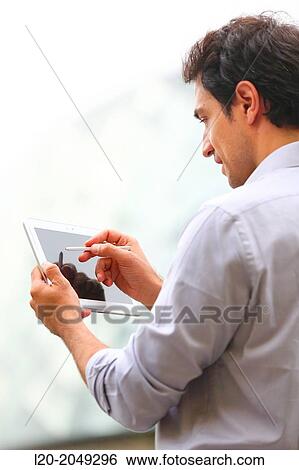 Business man with tablet in business center. San Sebastian Technology Park. Donostia. Gipuzkoa. Basque Country. Spain. View Large Photo Image Stock Photograph - Business man with tablet in business center. San Sebastian Technology Park. Donostia. Gipuzkoa. Basque Country. Spain.. Fotosearch