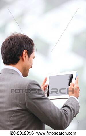 Business man with tablet in business center. San Sebastian Technology Park. Donostia. Gipuzkoa. Basque Country. Spain. View Large Photo Image Stock Photograph - Business man with tablet in business center. San Sebastian Technology Park. Donostia. Gipuzkoa. Basque Country. Spain.. Fotosearch