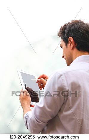 Business man with tablet in business center. San Sebastian Technology Park. Donostia. Gipuzkoa. Basque Country. Spain. View Large Photo Image Stock Photography - Business man with tablet in business center. San Sebastian Technology Park. Donostia. Gipuzkoa. Basque Country. Spain.. Fotosearch