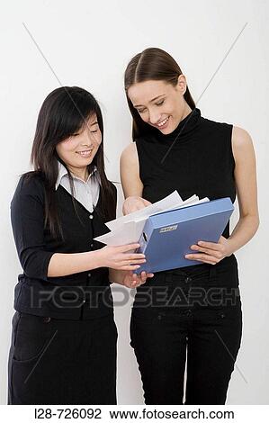 Stock Image - Business People Discussing Paperwork. Fotosearch