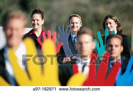 Stock Image - Business people outdoors with hands. Fotosearch