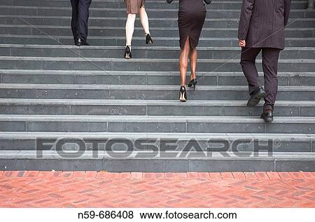 Business people walking up steps View Large Photo Image Stock Photo - Business people walking up steps. Fotosearch