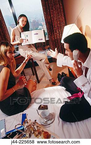 Business people working in a hotel room View Large Photo Image Stock Photo - Business people working in a hotel room. Fotosearch