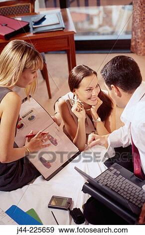 Stock Photo - Business people working in a hotel room. Fotosearch