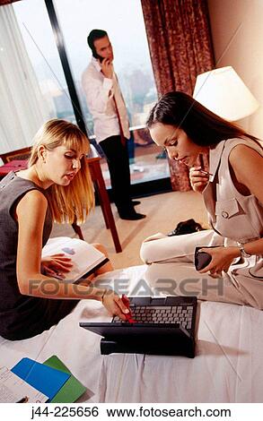 Business people working in a hotel room View Large Photo Image Stock Photograph - Business people working in a hotel room. Fotosearch