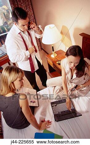 Business people working on bed in hotel room View Large Photo Image Stock Photography - Business people working on bed in hotel room. Fotosearch