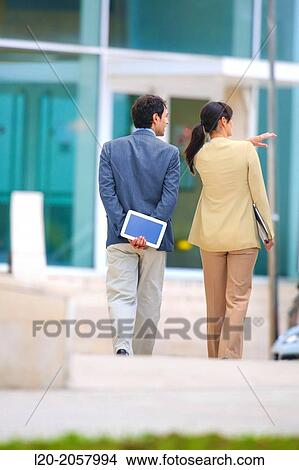 Business woman and businessman walking in business center. San Sebastian Technology Park. Donostia. Gipuzkoa. Basque Country. Spain. View Large Photo Image Picture - Business woman and businessman walking in business center. San Sebastian Technology Park. Donostia. Gipuzkoa. Basque Country. Spain.. Fotosearch