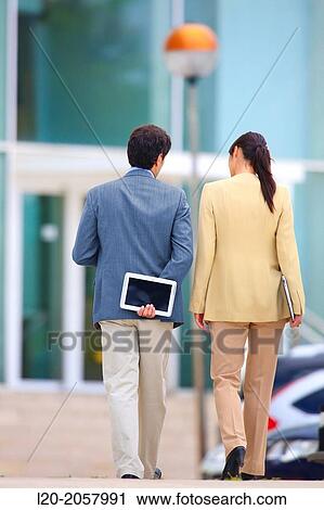 Business woman and businessman walking in business center. San Sebastian Technology Park. Donostia. Gipuzkoa. Basque Country. Spain. View Large Photo Image Stock Image - Business woman and businessman walking in business center. San Sebastian Technology Park. Donostia. Gipuzkoa. Basque Country. Spain.. Fotosearch