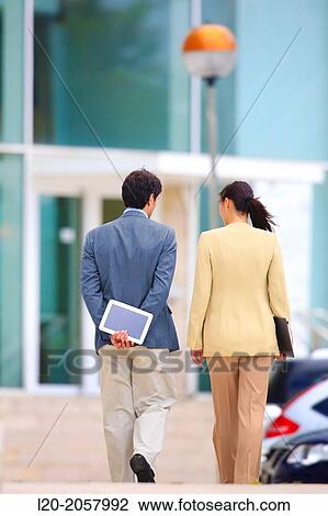 Business woman and businessman walking in business center. San Sebastian Technology Park. Donostia. Gipuzkoa. Basque Country. Spain. View Large Photo Image Stock Image - Business woman and businessman walking in business center. San Sebastian Technology Park. Donostia. Gipuzkoa. Basque Country. Spain.. Fotosearch