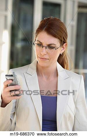 Business woman checking messages View Large Photo Image Stock Image - Business woman checking messages. Fotosearch