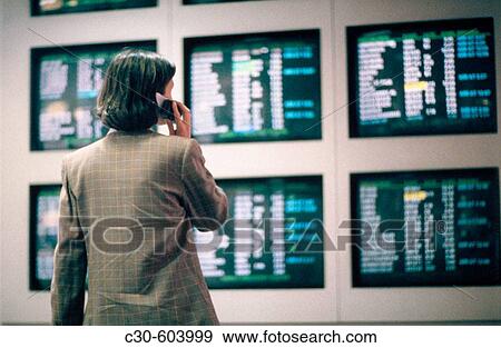 Business woman checks airline flight schedules View Large Photo Image Stock Photo - Business woman checks airline flight schedules. Fotosearch