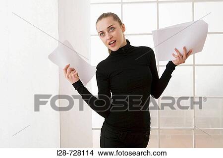 Picture - business woman holding documents, smiling. Fotosearch