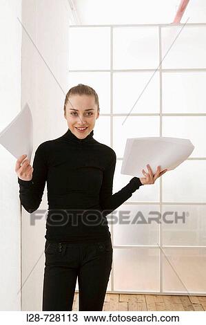 business woman holding documents, smiling View Large Photo Image Stock Image - business woman holding documents, smiling. Fotosearch