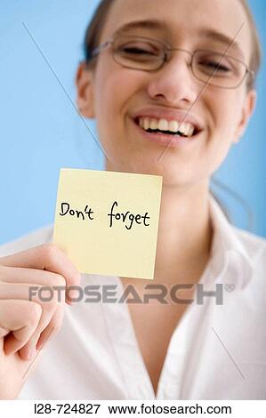 Stock Photo - business woman holding sticky note. Fotosearch