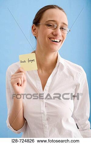 Stock Photograph - business woman holding sticky note. Fotosearch
