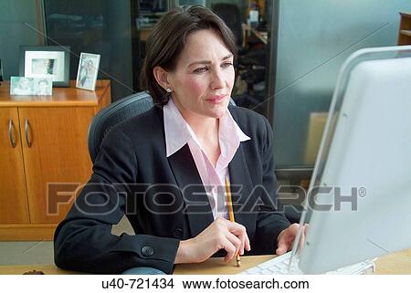 Business woman in office View Large Photo Image Picture - Business woman in office. Fotosearch