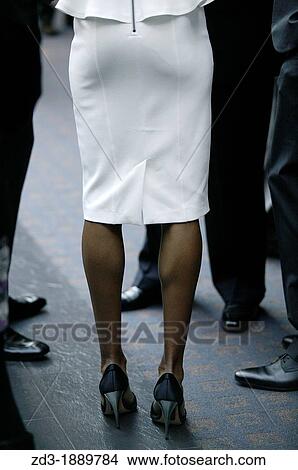 business woman in white skirt and high heels with business men. View Large Photo Image Picture - business woman in white skirt and high heels with business men.. Fotosearch