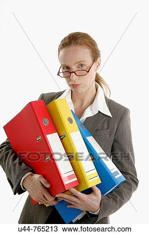 Stock Image - Business woman overwork stressed with so much work paper. Fotosearch