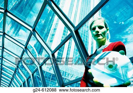 Business woman passing CD towards camera in glass tunnel or? web? View Large Photo Image Stock Photo - Business woman passing CD towards camera in glass tunnel or? web?. Fotosearch