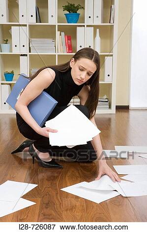 business woman picking up documents View Large Photo Image Stock Photo - business woman picking up documents. Fotosearch