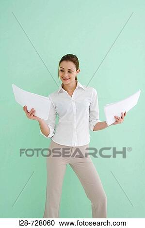 business woman standing and holding documents View Large Photo Image Stock Image - business woman standing and holding documents. Fotosearch