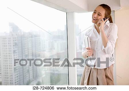 Stock Photograph - Business woman talking on phone. Fotosearch