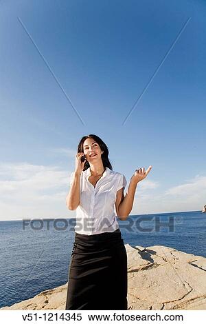 Business woman talking on the phone in a cliff in Ibiza, Balearic Islands View Large Photo Image Stock Photography - Business woman talking on the phone in a cliff in Ibiza, Balearic Islands. Fotosearch