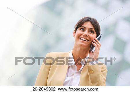 Stock Image - Business woman talking with smartphone business center. San Sebastian Technology Park. Donostia. Gipuzkoa. Basque Country. Spain.. Fotosearch