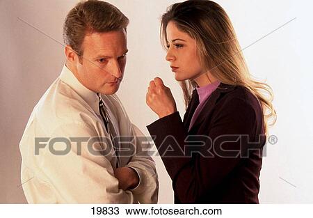 Stock Image - Business woman tells man off. Fotosearch