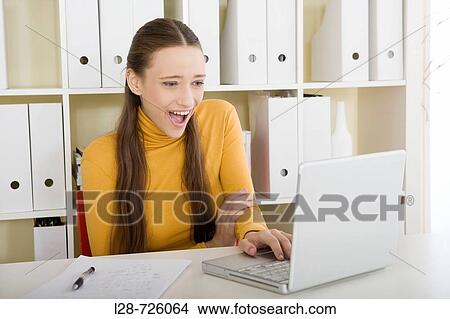 Picture - business woman using computer. Fotosearch